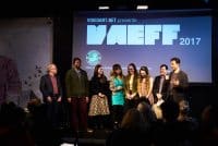 2017 Team Members Neco Turkienicz, Ellison Williams, Carolina Mandia, Festival Director Dan Fine, Gina Ginsburg, Claire Felonis, Festival Coordinator Sarah Telesca, and moderator Mark Alpert on stage.